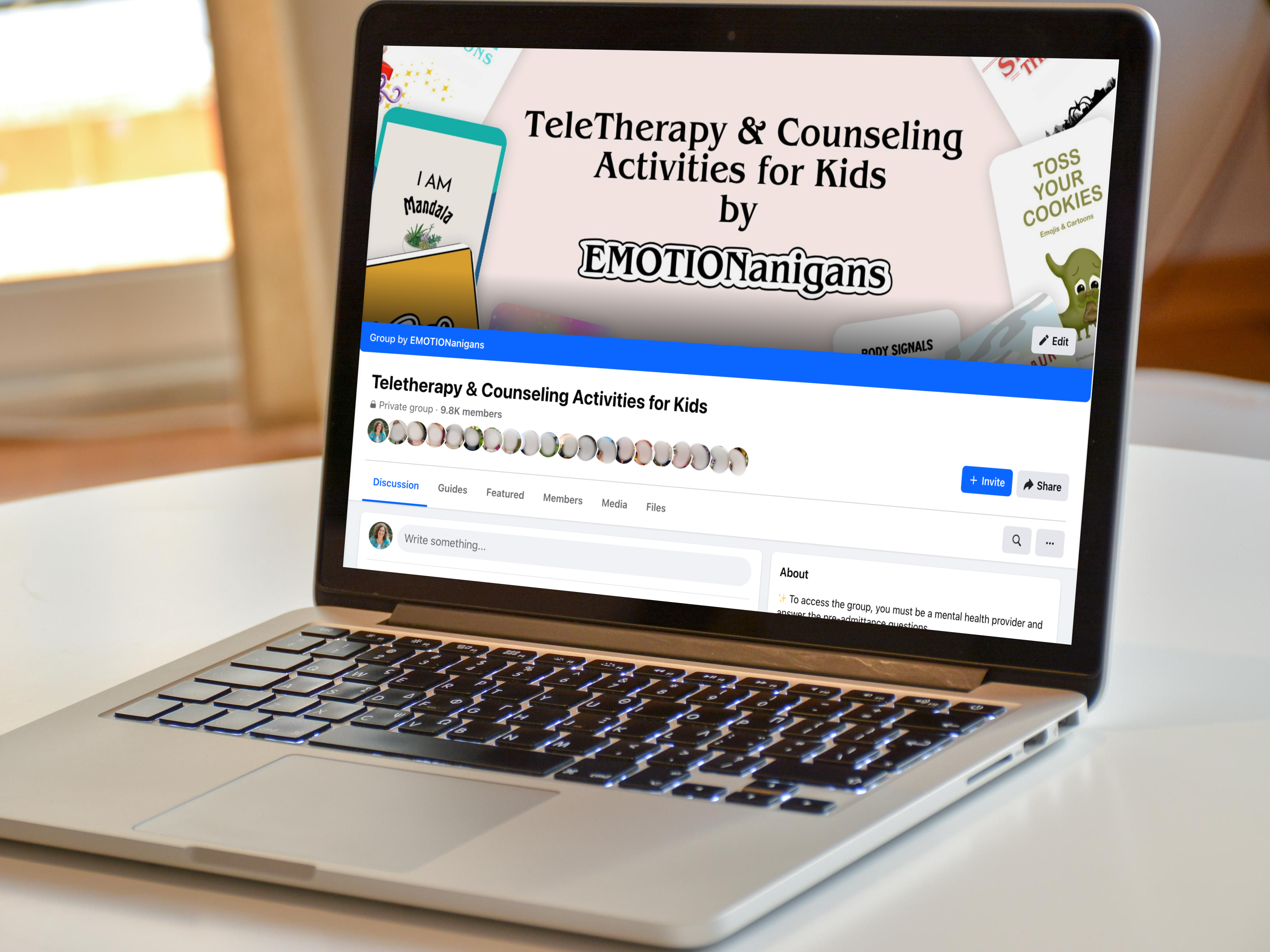 A laptop sits on a white table displaying a Facebook group page titled "TeleTherapy & Counseling Activities for Kids by EMOTIONanigans." The cover photo features various playful images and text promoting children's teletherapy resources.